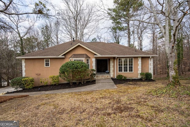 single story home with roof with shingles and stucco siding