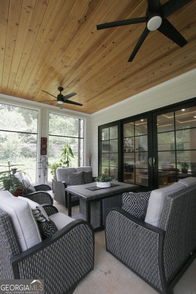 sunroom with wood ceiling and ceiling fan