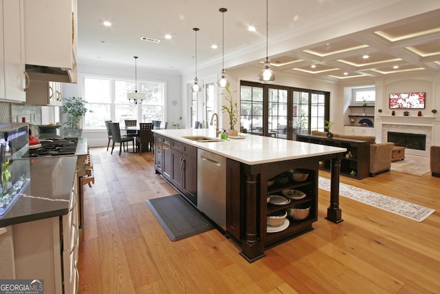 kitchen with dark brown cabinetry, stainless steel appliances, a fireplace, coffered ceiling, and a sink