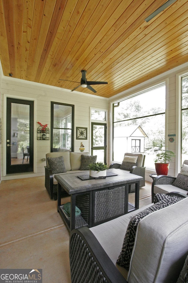 sunroom / solarium with a ceiling fan, a wealth of natural light, and wood ceiling