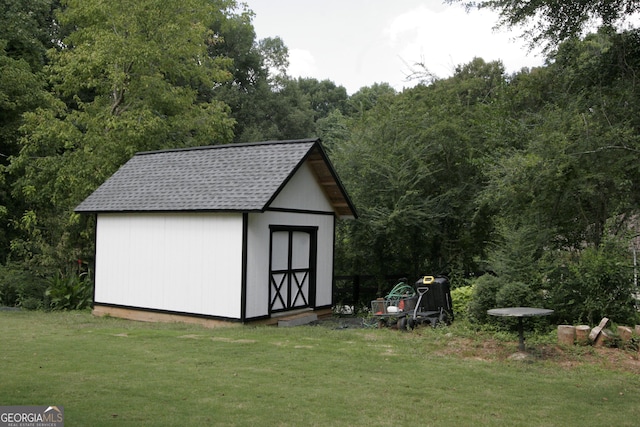 view of shed with a view of trees