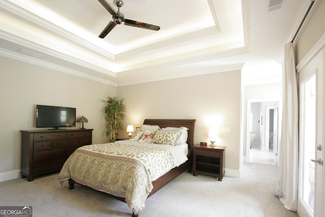 bedroom with visible vents, a tray ceiling, carpet flooring, and ornamental molding