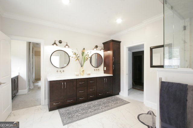 full bathroom with double vanity, marble finish floor, baseboards, and crown molding