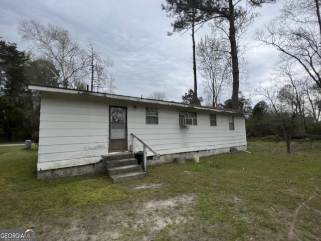 exterior space featuring entry steps and a front lawn