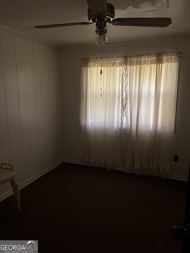 empty room featuring a ceiling fan and a healthy amount of sunlight