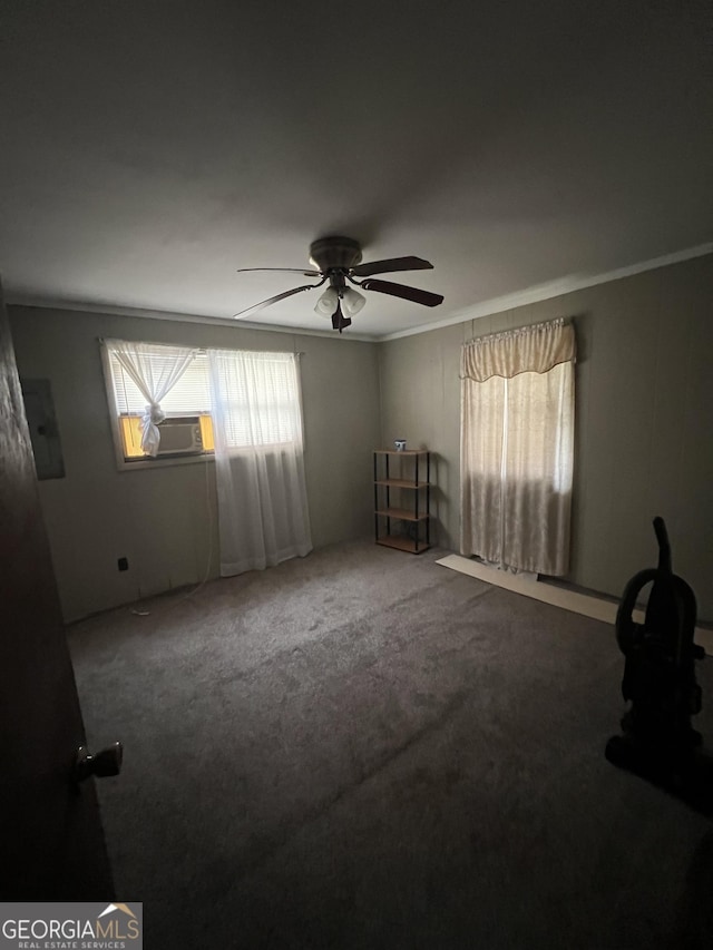 empty room with carpet, a ceiling fan, and crown molding