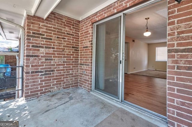 property entrance featuring brick siding