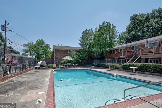 community pool featuring a patio and fence