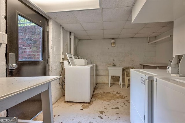 clothes washing area featuring washing machine and dryer and a sink