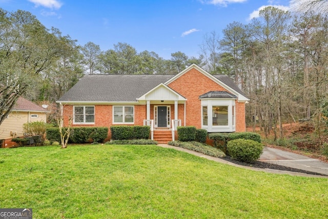 view of front of property featuring a front lawn and brick siding