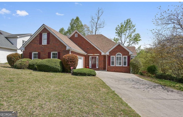 view of front of home with an attached garage, a front yard, and brick siding