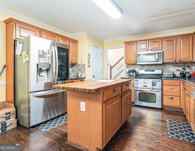 kitchen featuring wood counters, dark wood-type flooring, a center island, stainless steel appliances, and crown molding