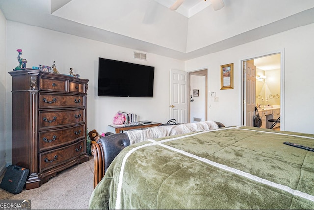 carpeted bedroom with visible vents, ceiling fan, and ensuite bathroom