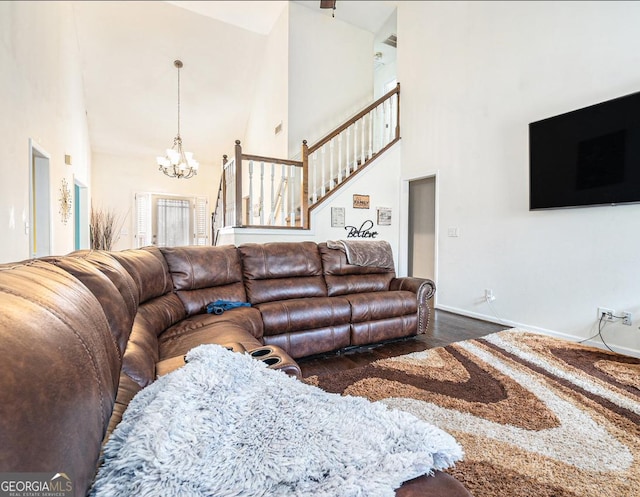 living room with baseboards, dark wood-style floors, stairway, a high ceiling, and a chandelier