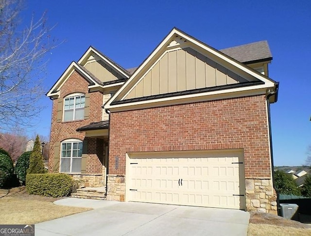 view of front of property with driveway, stone siding, and board and batten siding