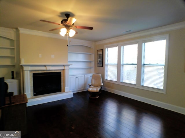 unfurnished living room with ornamental molding, dark wood-style flooring, built in shelves, and baseboards