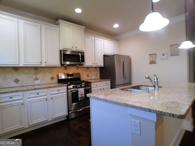 kitchen featuring backsplash, appliances with stainless steel finishes, ornamental molding, white cabinetry, and a sink