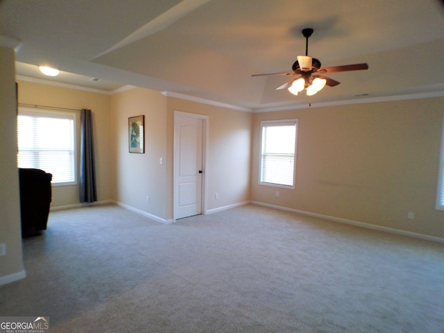 empty room featuring a healthy amount of sunlight, carpet floors, and ornamental molding