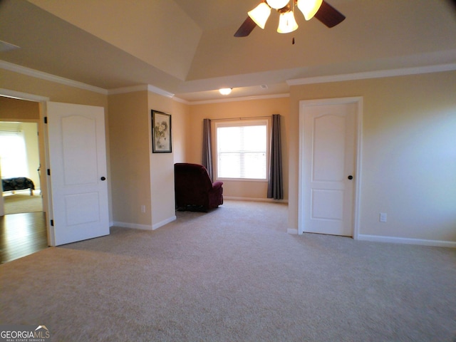 interior space with ornamental molding, carpet, lofted ceiling, and baseboards