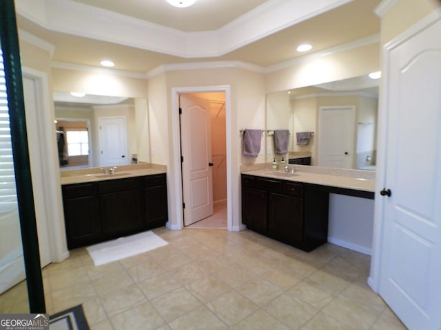 bathroom featuring a tray ceiling, two vanities, and a sink