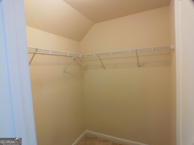 walk in closet with vaulted ceiling