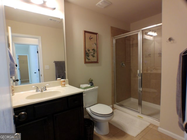 bathroom featuring tile patterned flooring, toilet, vanity, visible vents, and a stall shower