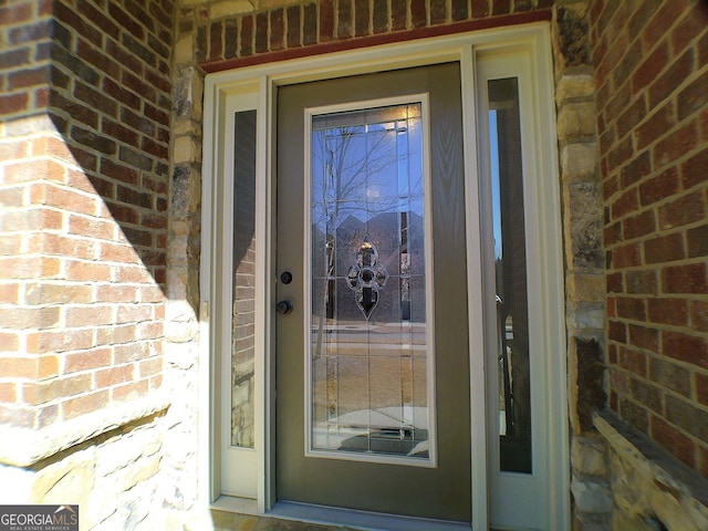 property entrance with brick siding