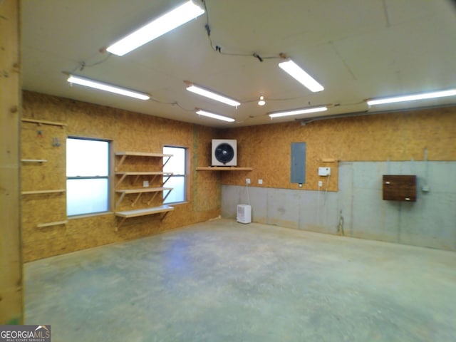 interior space featuring electric panel and concrete flooring