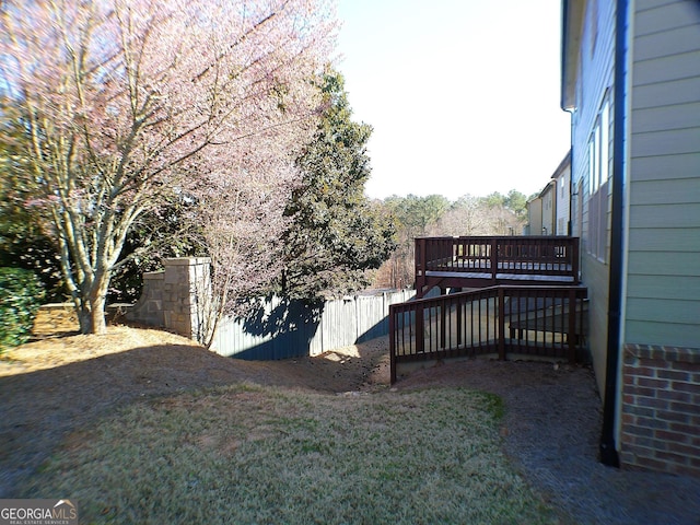 view of yard with fence and a wooden deck