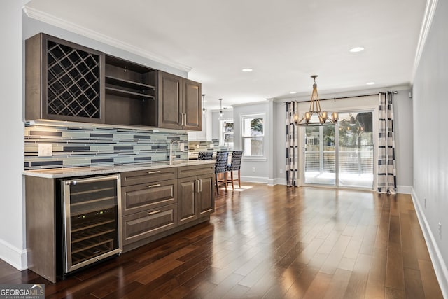 bar with beverage cooler, dark wood-type flooring, a sink, backsplash, and crown molding