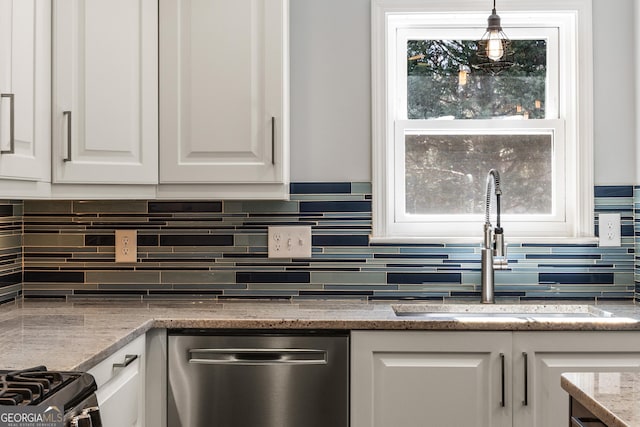 kitchen with light stone counters, a sink, white cabinetry, stainless steel dishwasher, and backsplash