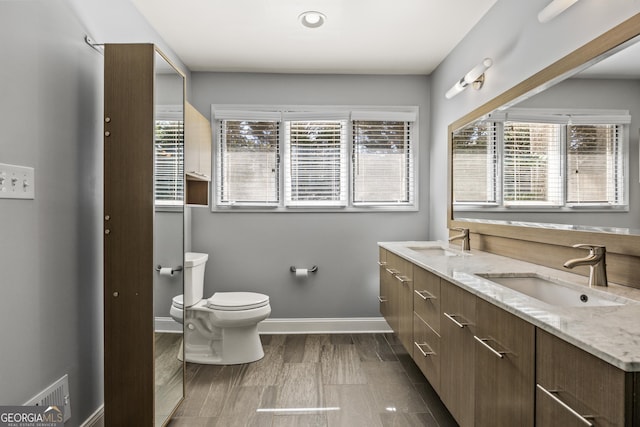 full bathroom featuring visible vents, a sink, toilet, and baseboards