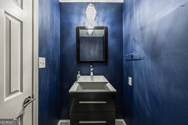 bathroom with vanity and an inviting chandelier