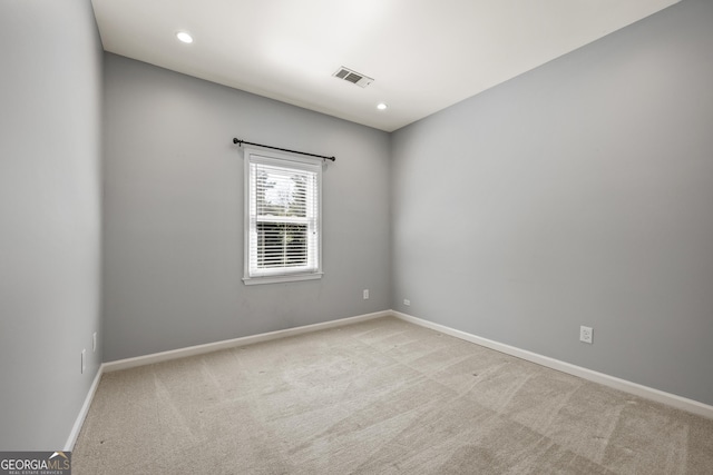 carpeted spare room with recessed lighting, visible vents, and baseboards