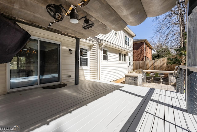 deck with ceiling fan and fence