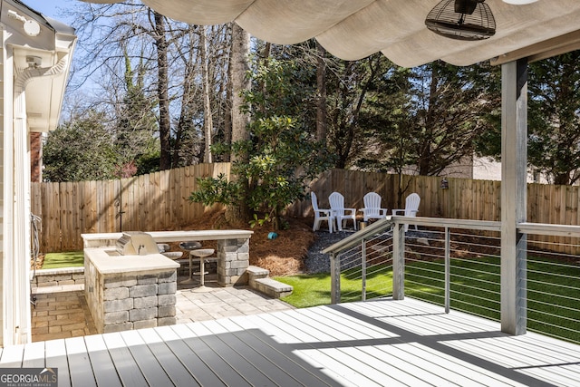 deck with a fenced backyard