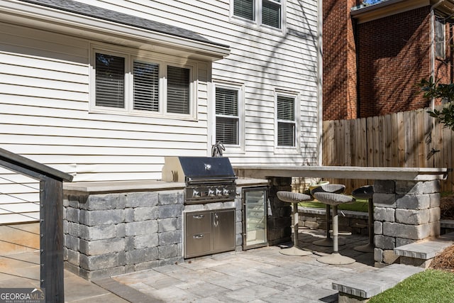 view of patio featuring a grill, fence, and area for grilling