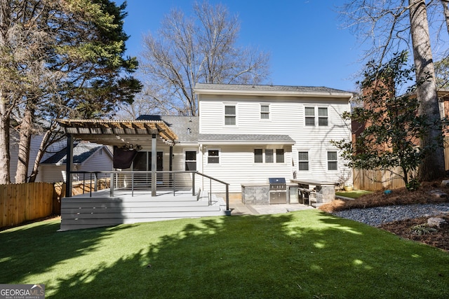 rear view of house with a yard, area for grilling, fence, a pergola, and a wooden deck