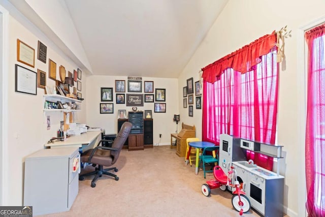 home office featuring lofted ceiling and light carpet