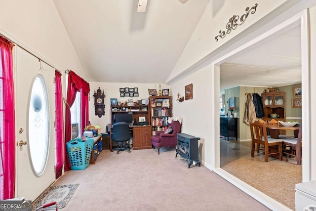 carpeted home office featuring vaulted ceiling