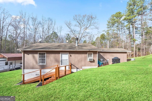 rear view of house with a deck, crawl space, and a lawn