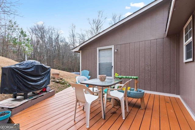 wooden terrace featuring outdoor dining area and area for grilling