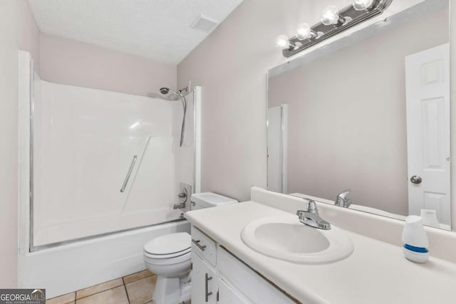 full bathroom with a textured ceiling, tile patterned flooring, toilet, vanity, and tub / shower combination