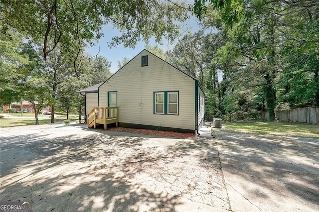 back of house with fence