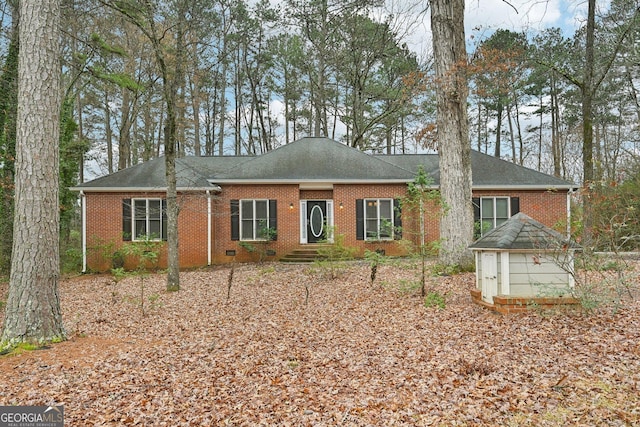 ranch-style home with crawl space, a shingled roof, and brick siding