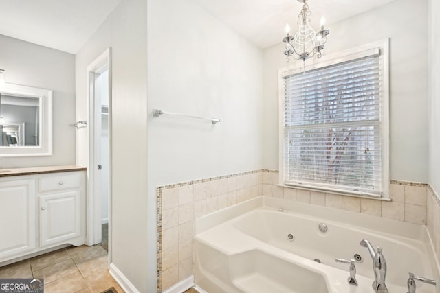 bathroom with a sink, a notable chandelier, a whirlpool tub, and tile patterned floors