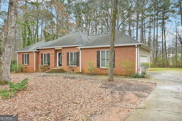 single story home featuring a garage, brick siding, crawl space, and a shingled roof