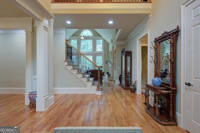 8440 Woodland Brooke Trl, Cumming, GA 30028 - entrance foyer featuring decorative columns, stairs, wood finished floors, ornamental molding, and baseboards