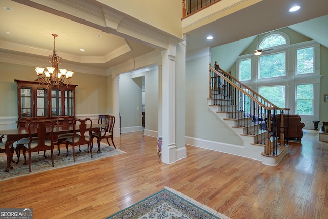 8440 Woodland Brooke Trl, Cumming, GA 30028 - dining room with wood finished floors, a chandelier, stairway, decorative columns, and ornamental molding