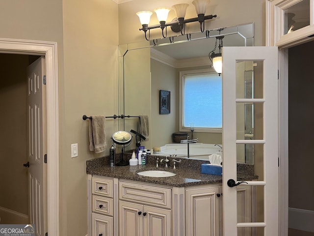 bathroom with ornamental molding and vanity